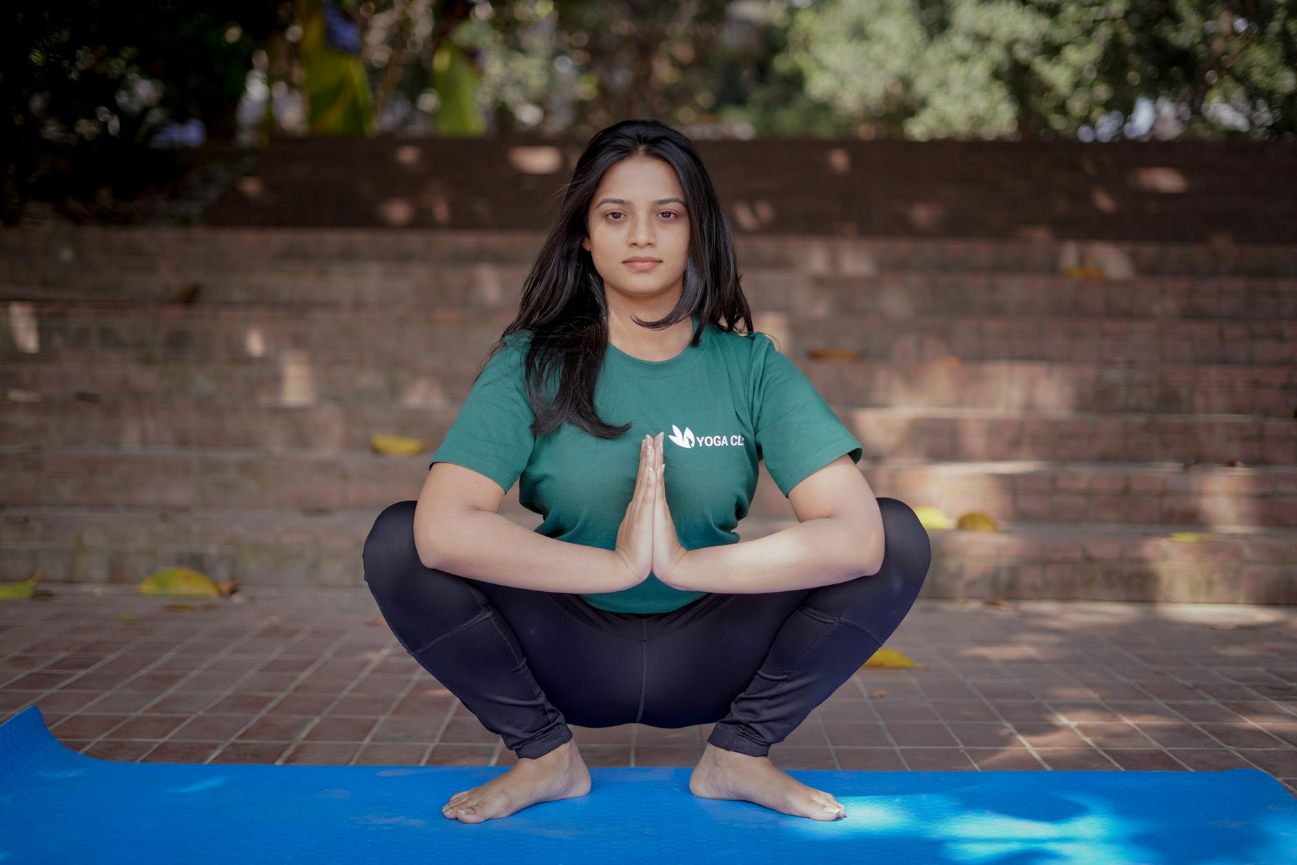 woman squatting and exercising yoga