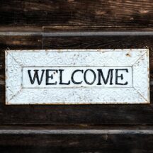 black and white wooden welcome sign