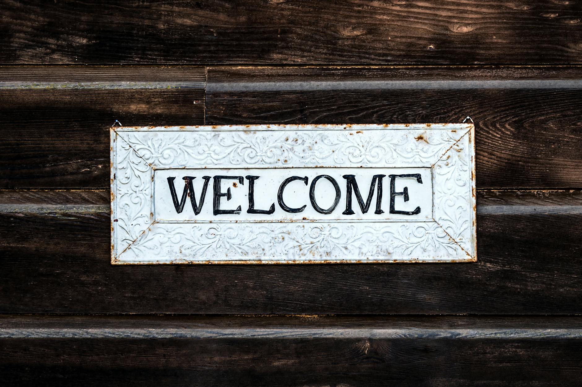 black and white wooden welcome sign